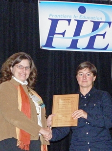 The award for the best engineering education research paper and presentation at the Frontiers in Education conference in Washington, D.C. went to a team of ASU faculty members. The paper’s lead author and presenter was Glenda Stump, a post doctoral associate in ASU’s School of Social and Family Dynamics. One of her co-authors, associate professor Jenefer Husman (left), is pictured accepting the award.