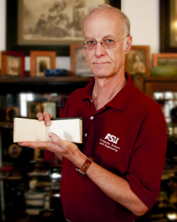 ASU researcher Jeremy Rowe displays a sketchbook from his collection of historic illustrations and photographs. The book, one of the earliest visual documentations of Arizona, is the focus of a story featured in an upcoming episode of the popular PBS series “History Detectives.” Photo: Blaine Coury/ASU.