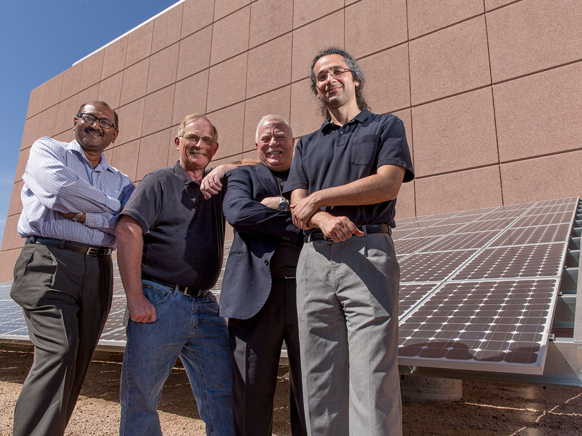 An array of photovoltaic modules built recently at the Macro Technology Works facility at the Arizona State University Research Park are being used to develop systems designed to boost the productivity and reliability of solar power generation facilities. Pictured at the site are leading members of the project team. From left to right: Devarajan Srinivasan, Jeffery Frye, Andreas Spanias, and Cihan Tepedelenlioglu.