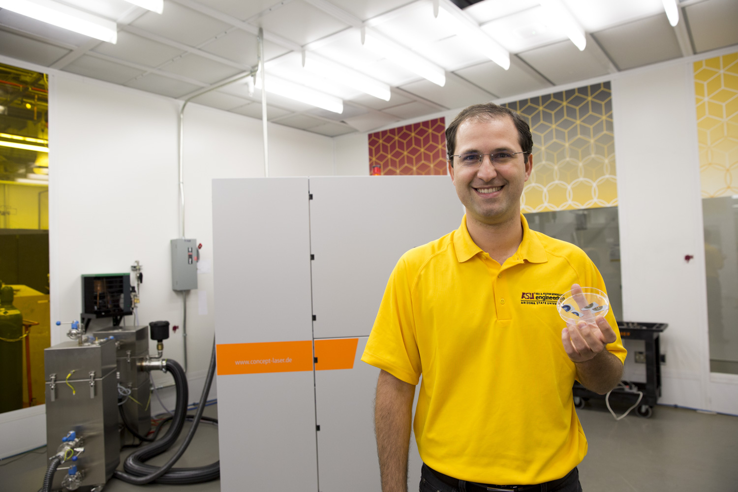 Bruno Azeredo displays optical gratings used in microscopes and spectrophotometers.