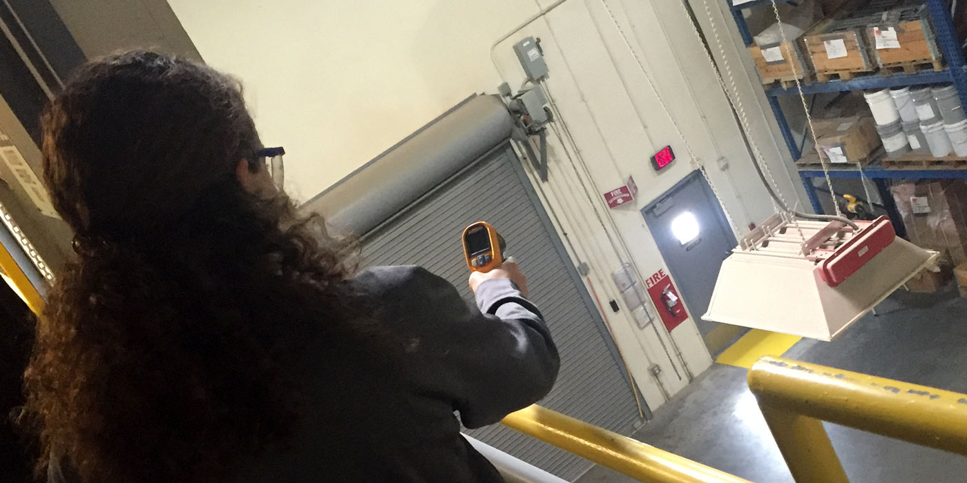 Mechanical engineering undergraduate student Katilin Kreck takes a measurement in a manufacturing facility.