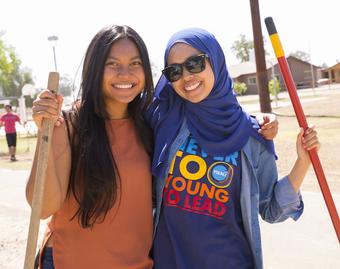 Photo of two girls outdoors with a caption of "Ni Putu Ika Pradnya Larasyati and Zawanah Razak getting hands-on experience through YESEALI. Photographer: Jessica Hochreiter/ASU"
