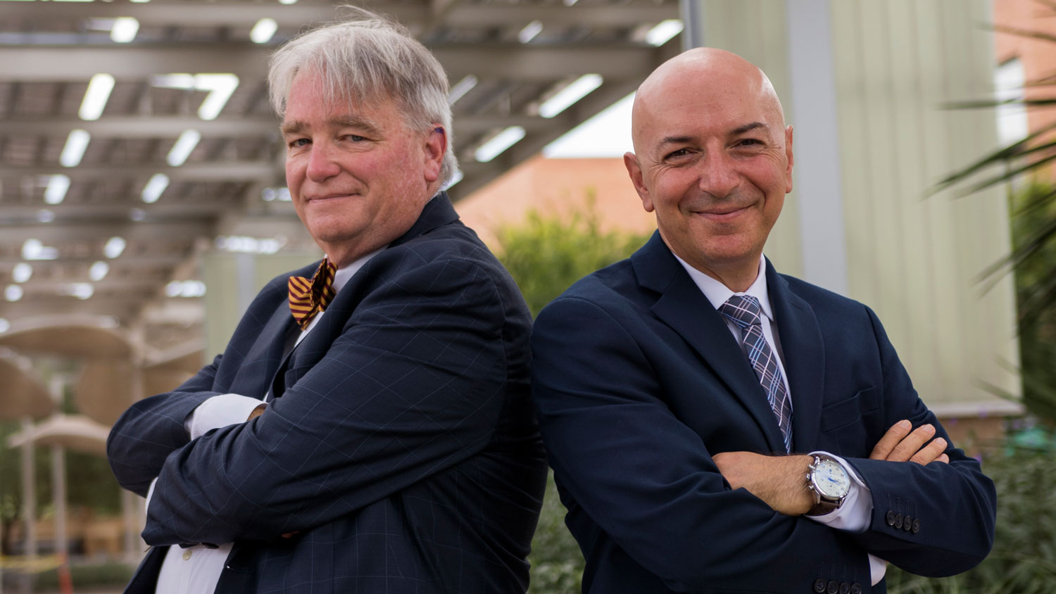 Photo of two men standing shoulder to shoulder with their arms crossed. Caption: Professors Dale S. Rogers and Bertan Bakkaloglu were named ON Semiconductor Professors of Business and Engineering, confirming their roles as leaders in their respective fields of supply chain management and electrical engineering.