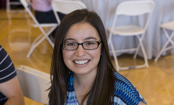 Photo of Taylor Wiehn sitting and holding the award. Caption: Taylor Wiehn, in inaugural recipient of the Fulton Undergraduate Research Initiative Alumni Award, displays the award at the Spring 2017 FURI Luncheon, April 21, 2017. Photographer: Marco Alexis-Chaira/ASU