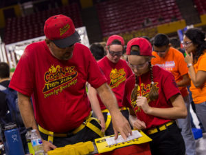 A mentor works with a student team member at the FIRST Robotics Competition Arizona State Championship at Wells Fargo Arena. 