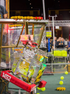 A robot hangs on a tower at the FIRST Robotics Competition Arizona State Championship at Wells Fargo Arena