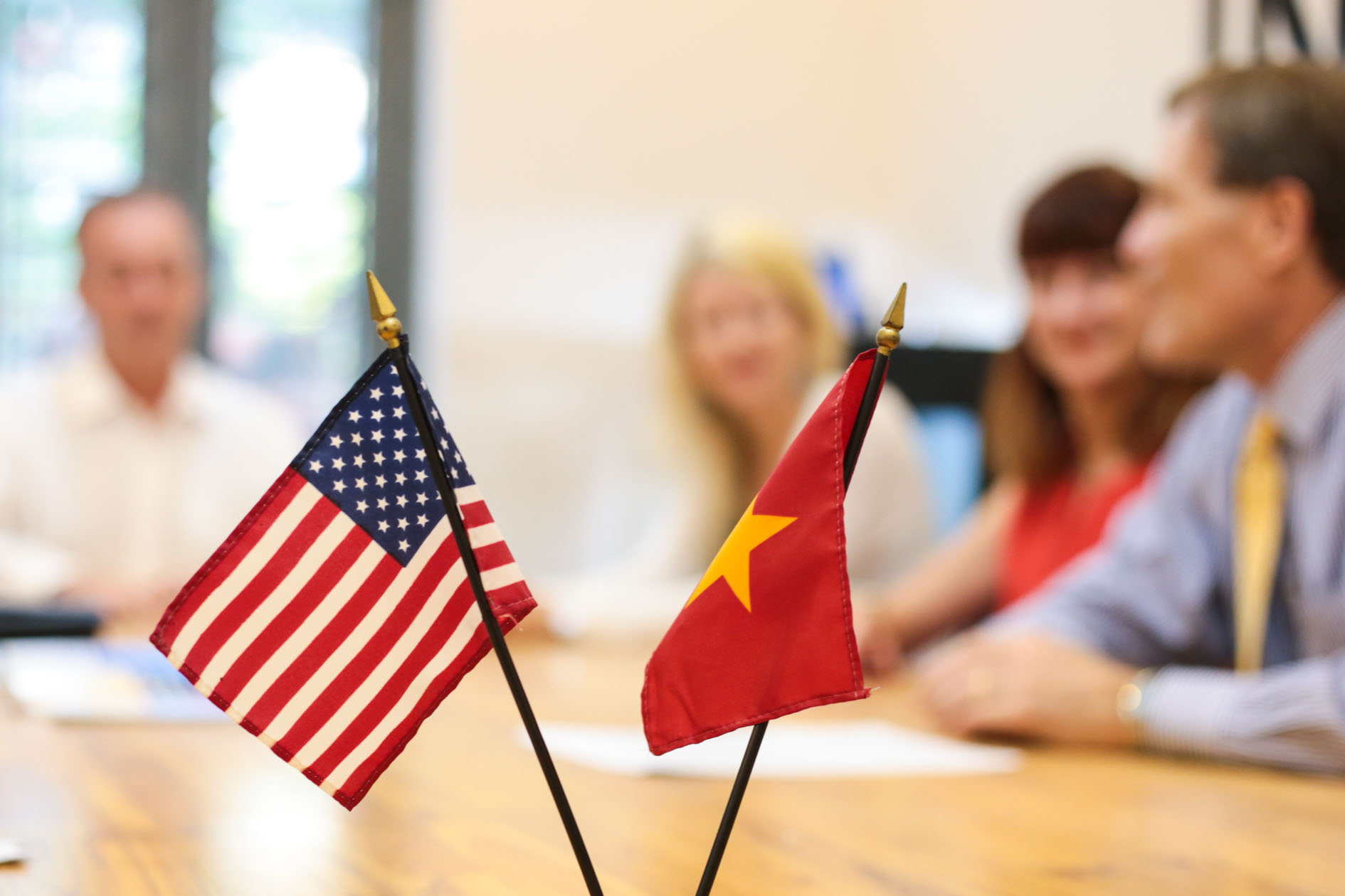 Photo of the U.S. flag next to a Vietnam flag on a table
