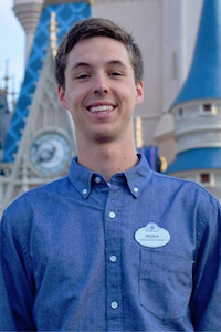 Portrait of Noah Livingston in front of a Disney castle