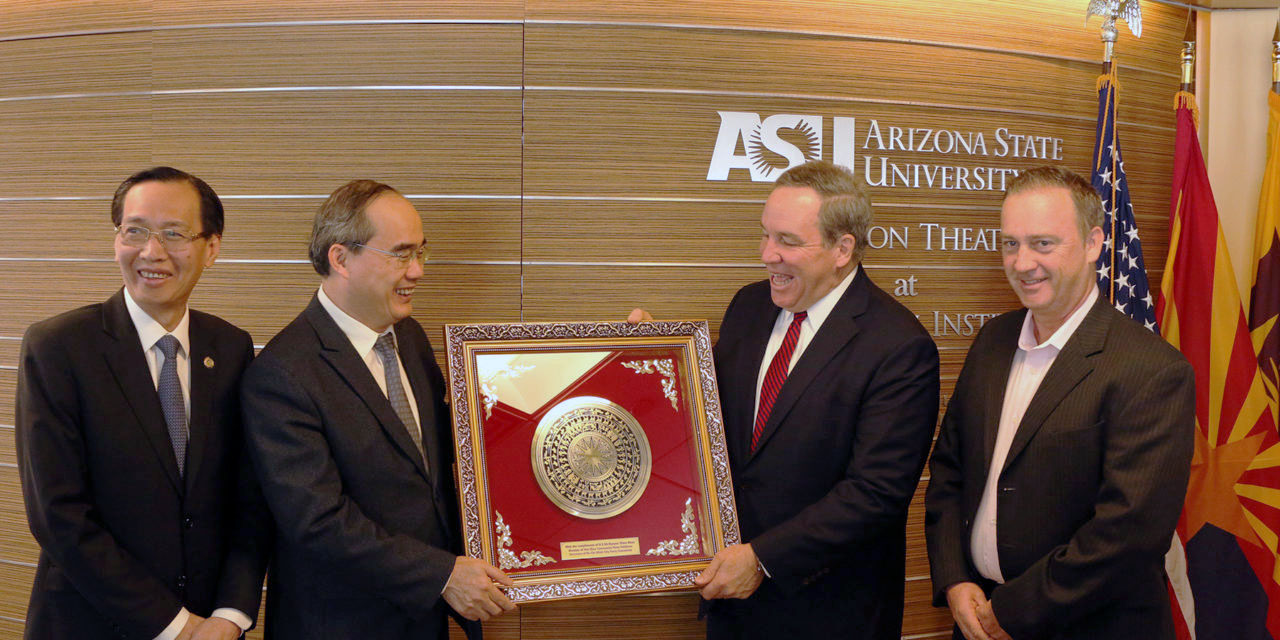 Photo of four men, two of which are holding a plaque. Caption: Members of the Ho Chi Minh City People’s Committee present ASU officials with a plaque of appreciation during the launch of the HCMC Smart Sustainable City Project collaboration.