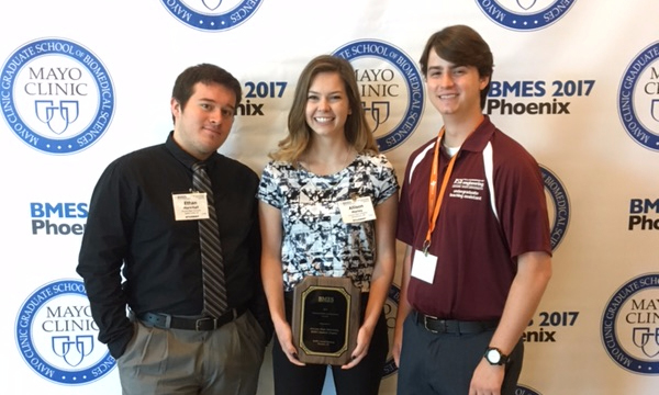 Three students standing with the middle one holding a plaque. Caption: After giving their Chapter Best Practice speech at the convention, current president Ethan Marschall, former president Allison Marley and current vice president Scott Boege hold their BMES Commendable Achievement Award. Photo courtesy of Ethan Marschall