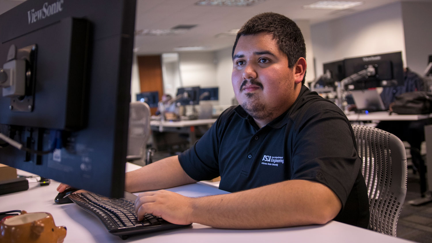 A man works at a computer.