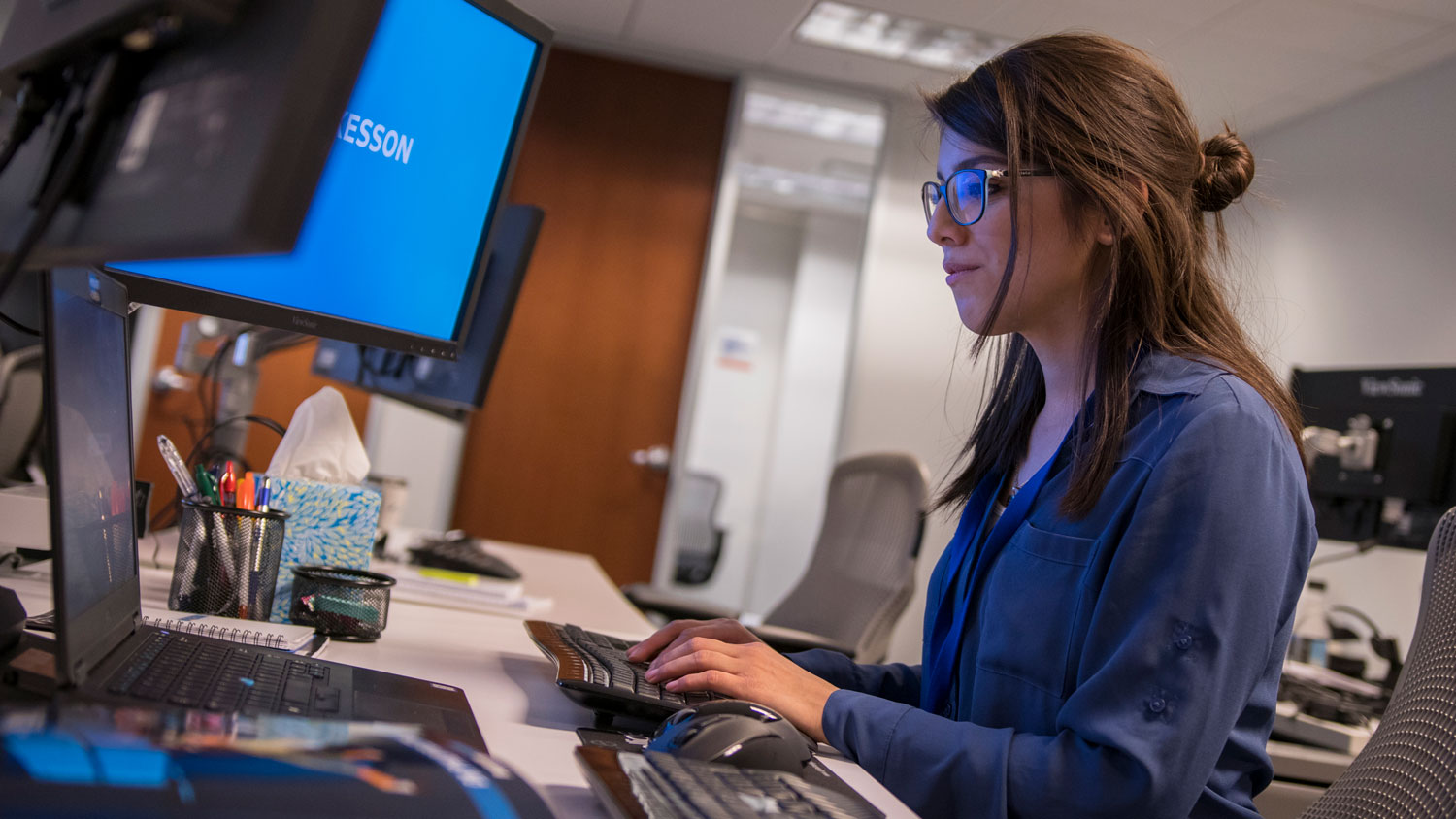 A woman works at a computer.