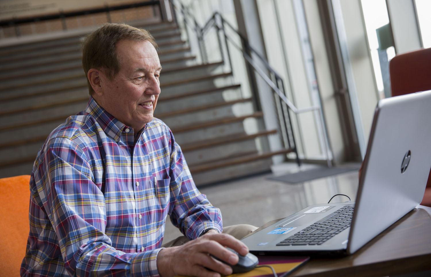 Photo of man sitting in front of a laptop. Caption: Arizona State University structural engineering alumnus John P. Nerison, PE, volunteers his free time by tutoring students from across the country online. He wants to give back to the engineering profession and community by helping more students thrive in their engineering education. Photographer: Jessica Hochreiter/ASU