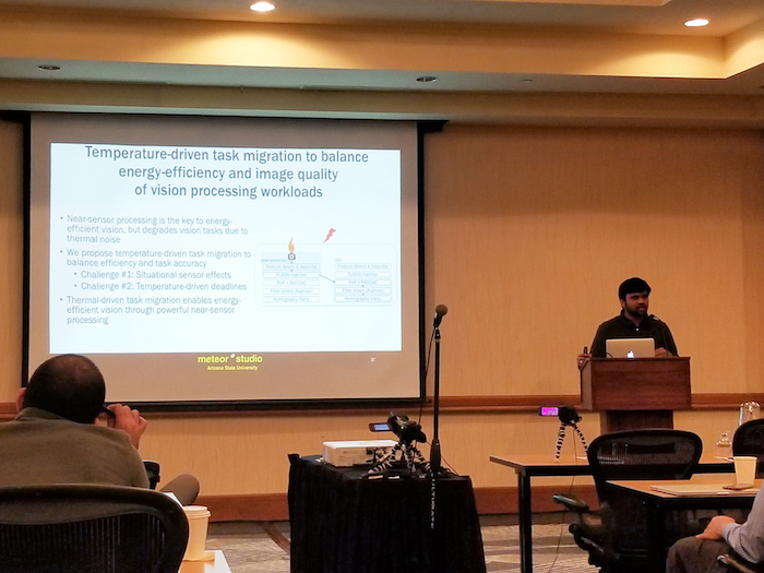 Photo of a man making a presentation in a classroom. Caption: Computer engineering (electrical engineering) graduate student Venkatesh Kodukula presents his research on improvements to mobile image capture and processing systems at ACM HotMobile ‘18. Kodukula was one of the two ASU students who had papers accepted by the conference. Photo courtesy of Robert LiKamWa.