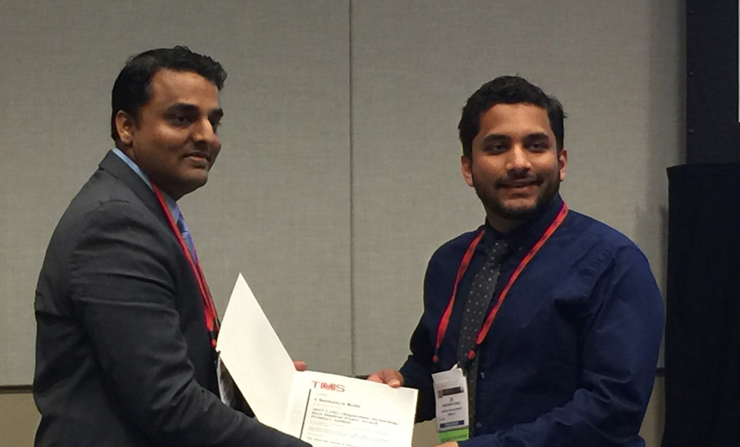 Photo of two men holding a certificate. Caption: Lead writer Chaitanya Kale accepts the Light Metals Division Magnesium Technology Award at the 147th Annual TMS Meeting for Best Student Paper. Photo courtesy of Chaitanya Kale.