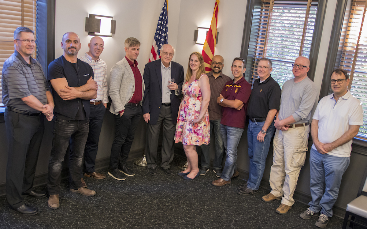 A group of 11 people standing. Caption: A reception for David Ferry (fifth from left) brought together fellow faculty members from ASU and other leading universities, along with former students, to applaud Ferry’s wide range of accomplishments as a researcher and his valuable guidance as a teacher, mentor and colleague. Photographer: Marco-Alexis Chaira/ASU 