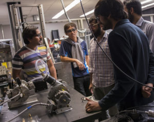 Five men standing inside a lab