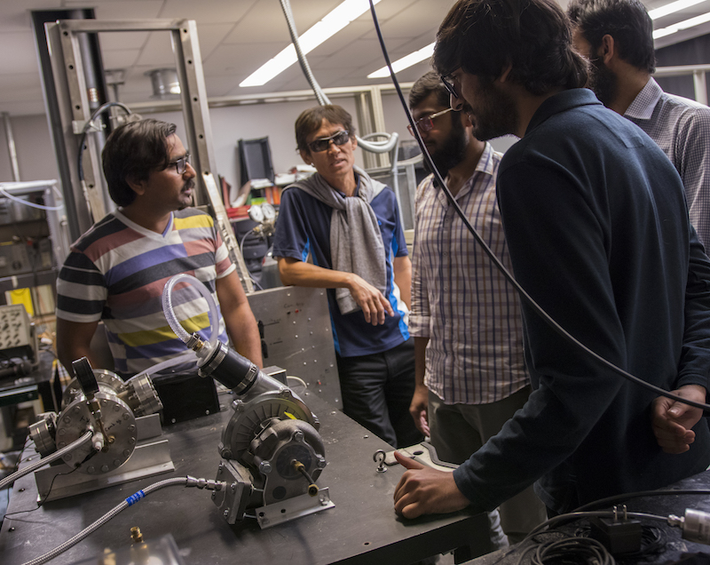 Five men standing inside a lab