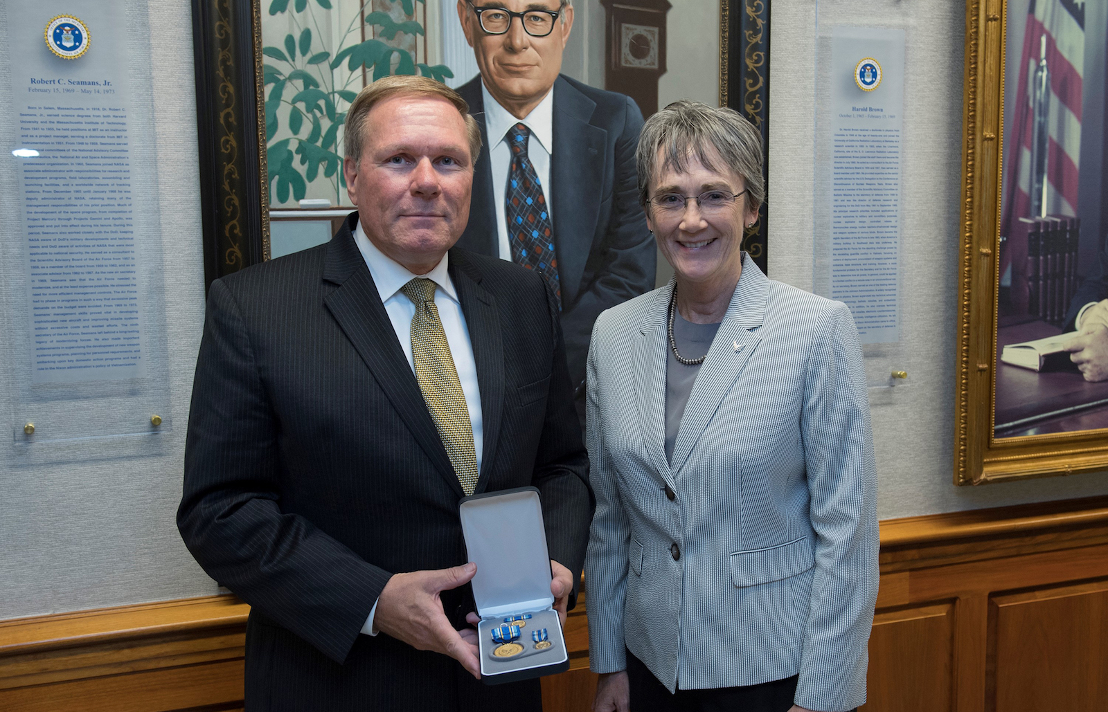 man holding Air Force medals standing next to woman