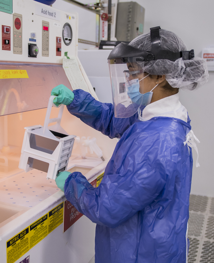 student in lab using equipment