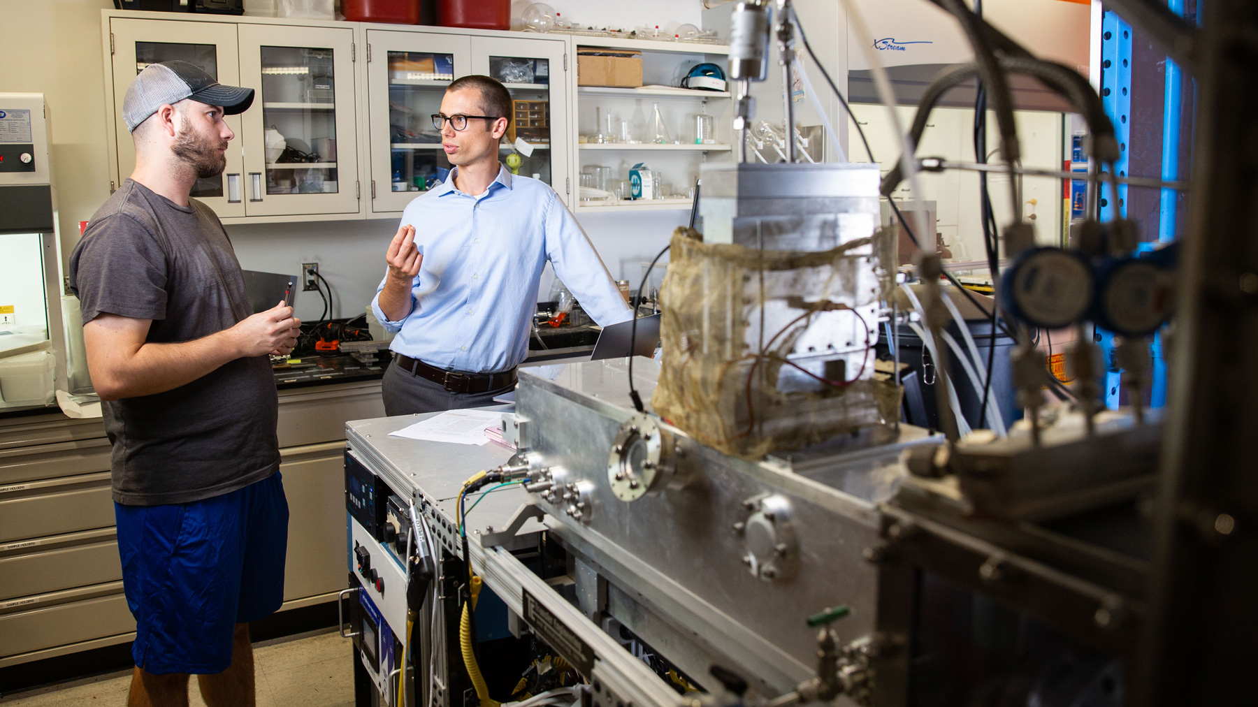 Two people talk in a lab.