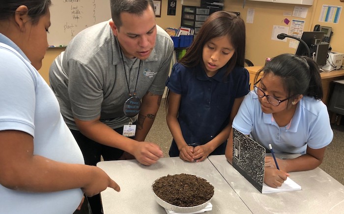 teacher talking with three students