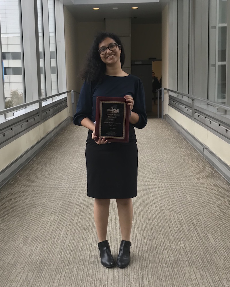 student holding a plaque