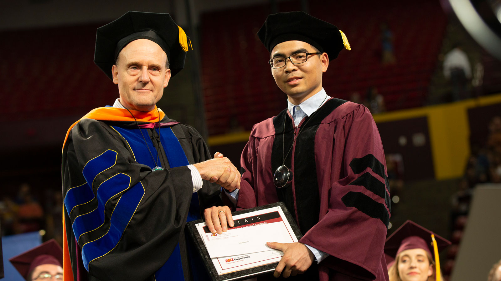 Stephen Phillips presents Houqiang Fu with the Palais Outstanding Doctoral Student Award.