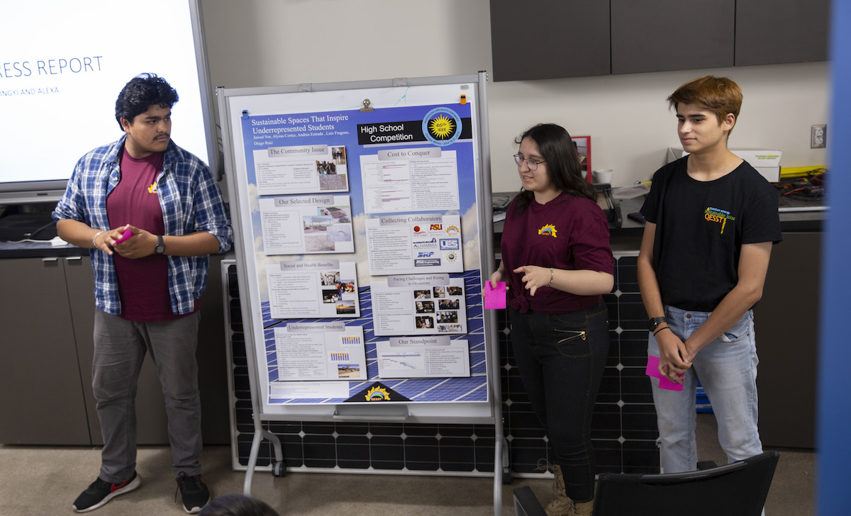 Three students giving a presentation