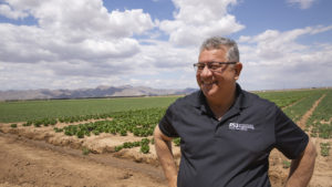 portrait of Rene Villalobos standing in a field