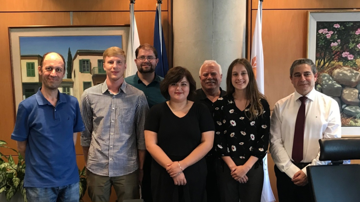 seven people standing in an office