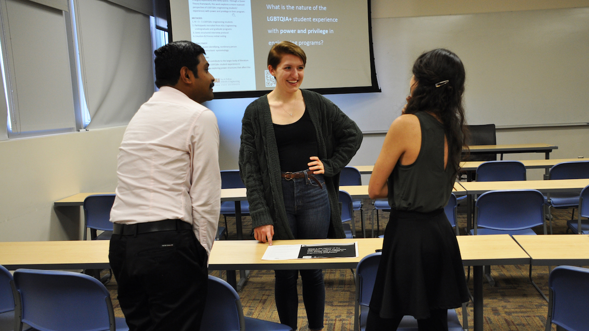Three students standing and talking