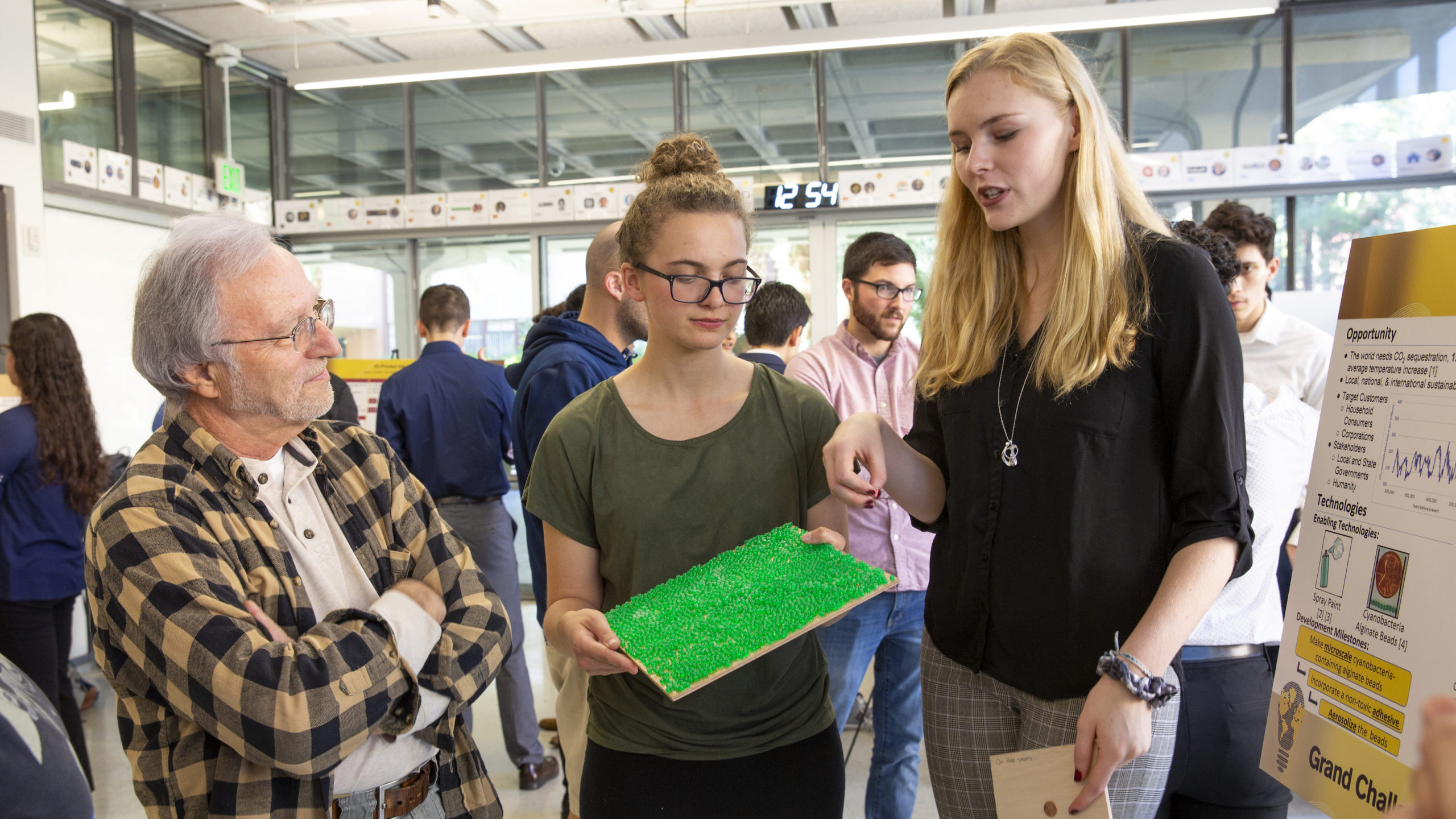 Students presenting a project to a man