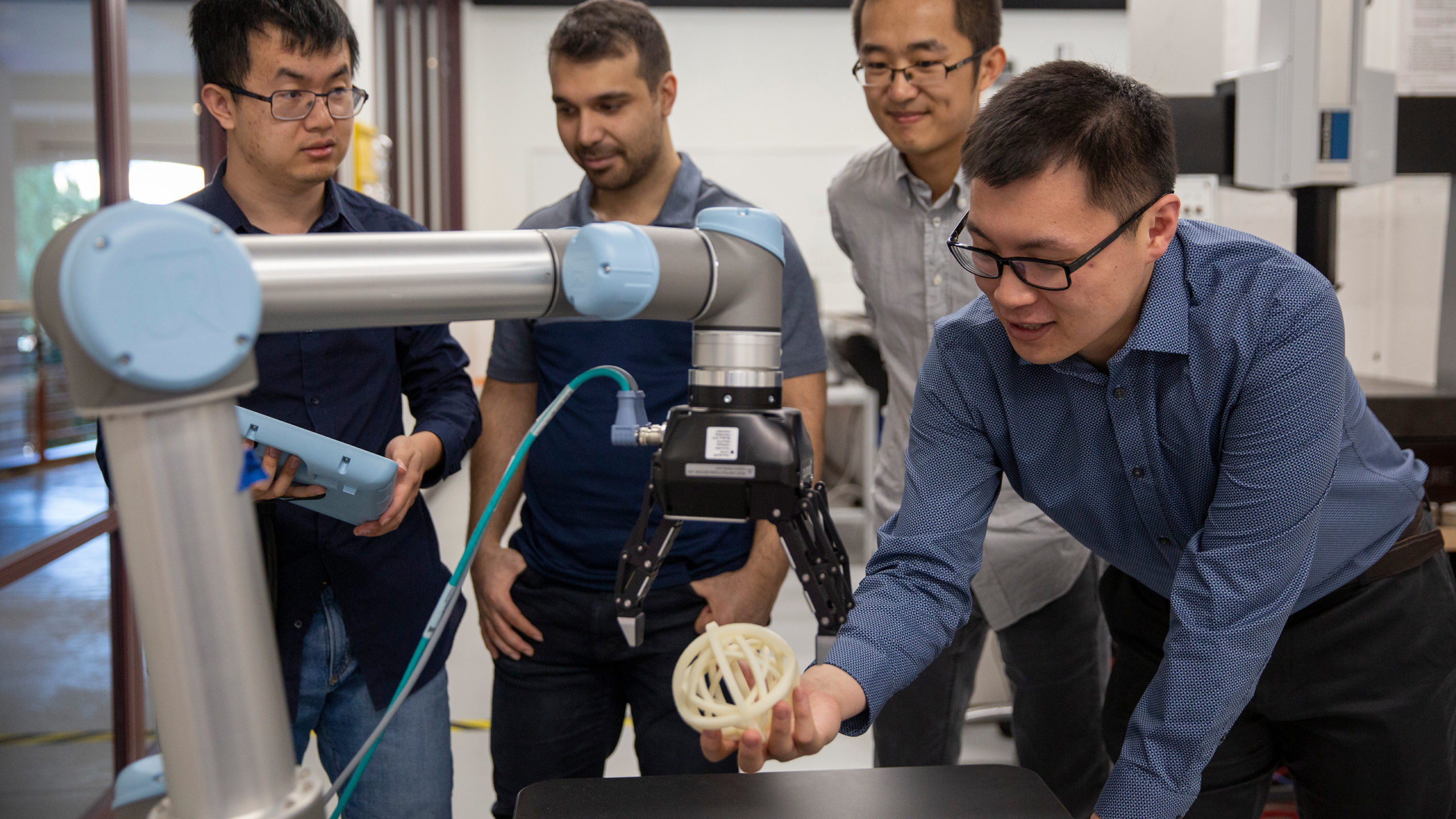 professor and students working with a 3D printed object