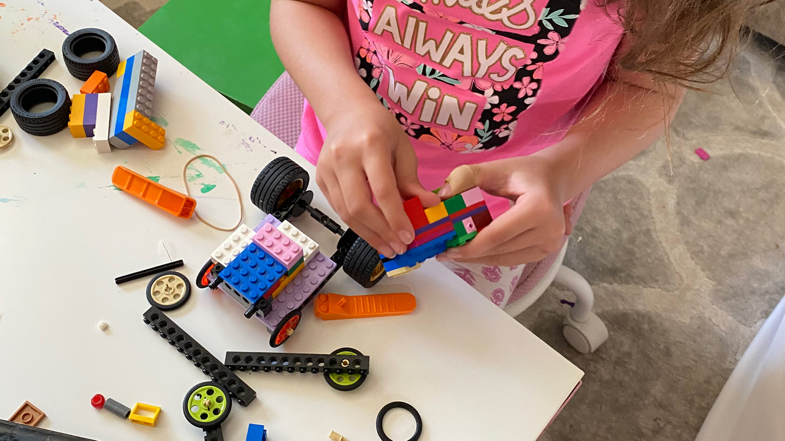 photo of a young girl building with LEGO