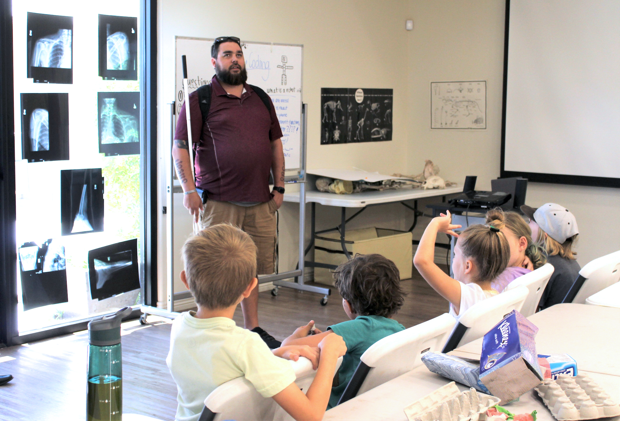 Bryan Duarte standing in front of young children