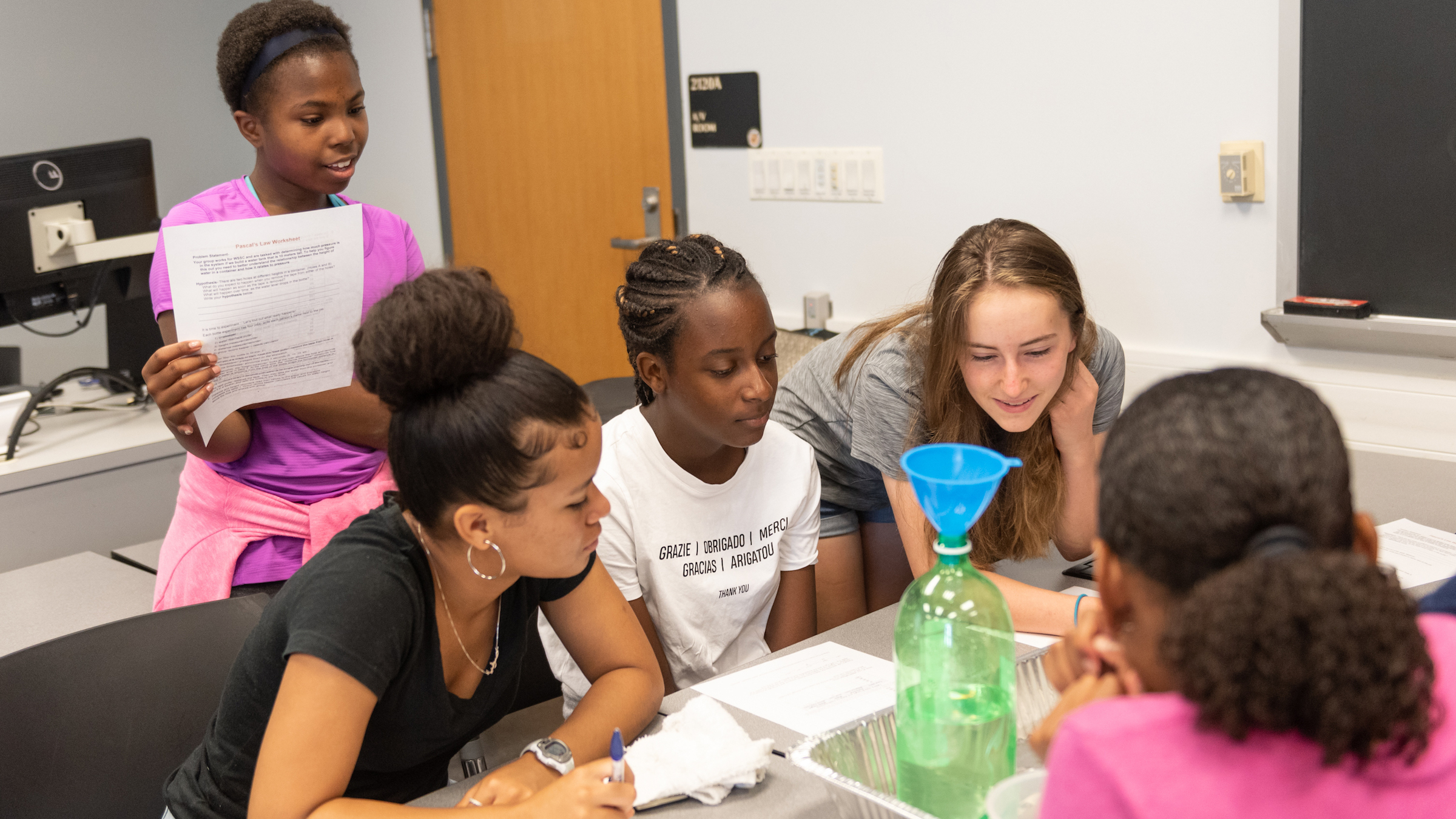 five young students working around a table