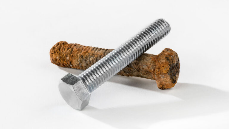 A photo of a rusty old bolt and a new bolt shows the destructive power of corrosion.