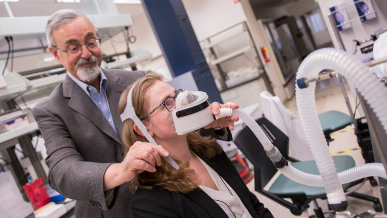 Stewart Mann and Mary Laura Lind testing device in lab