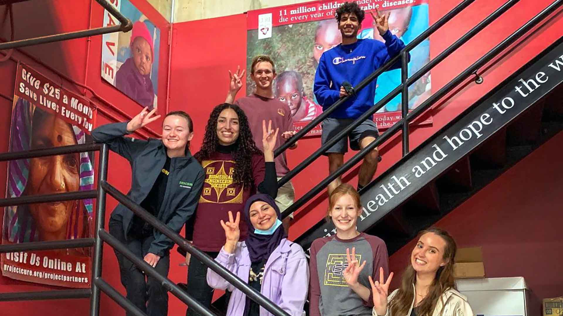 BMES students on a stair case during Project CURE event