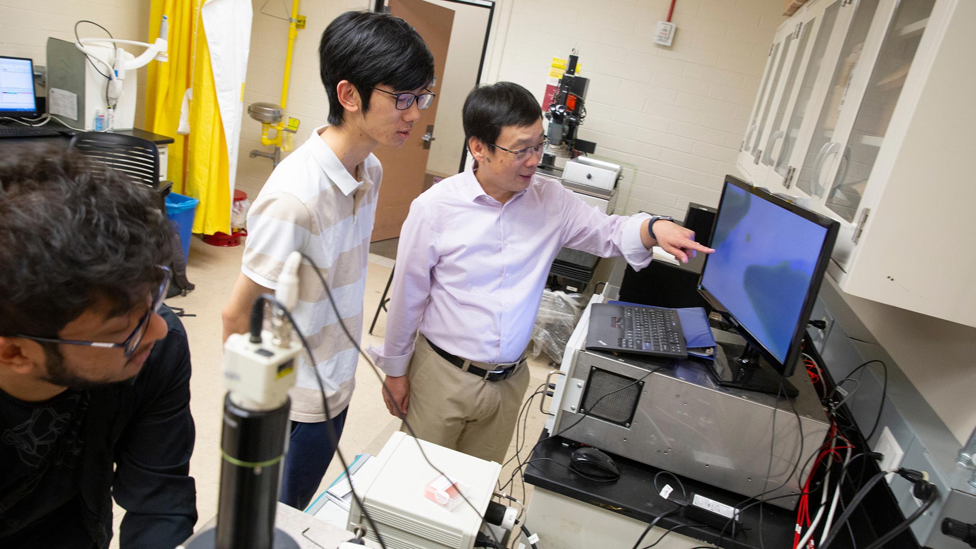faculty member with student in lab