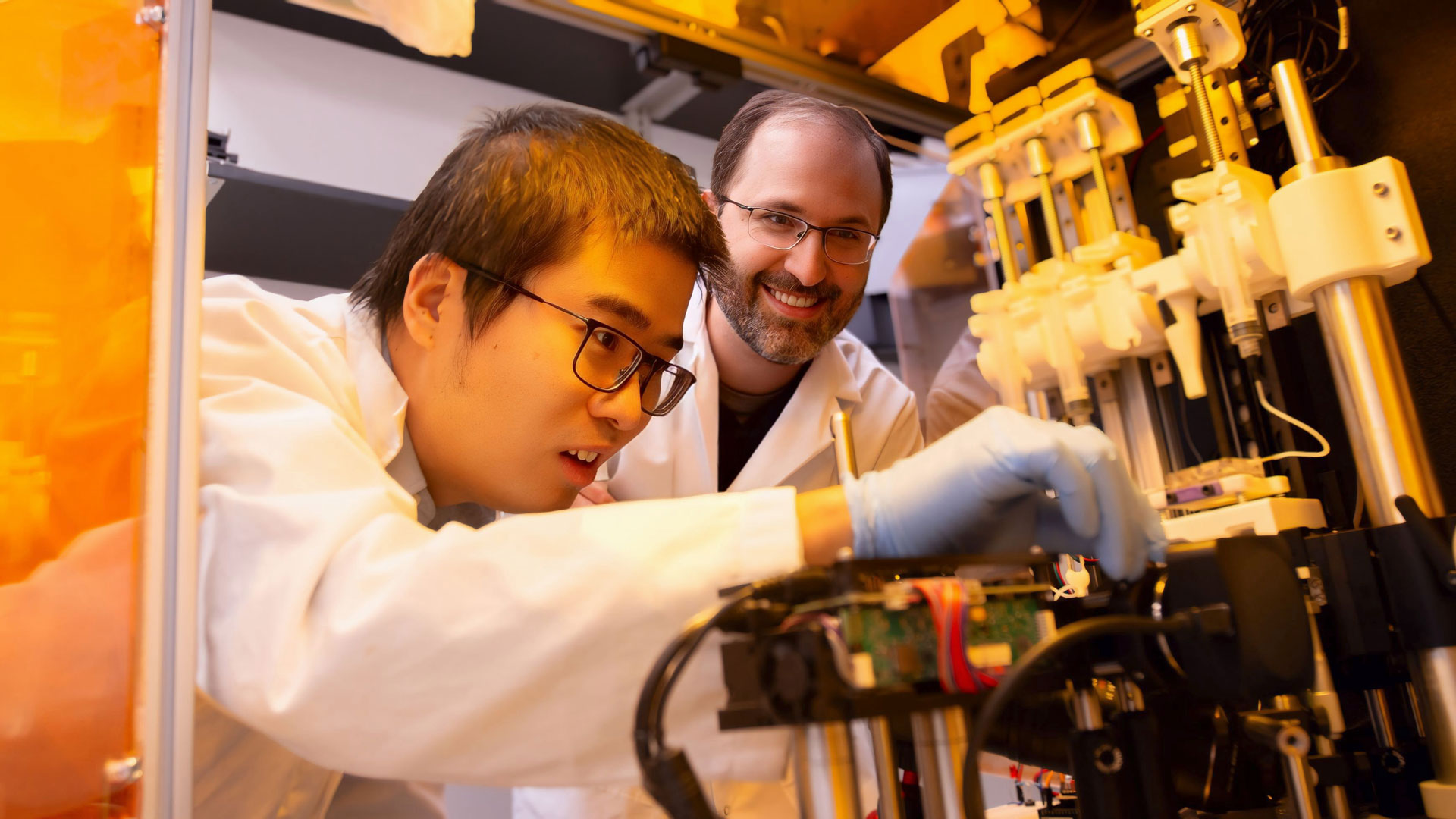 Xiangfan Chen and Bruno Azeredo working in the Advanced Manufacturing and Functional Device Laboratory