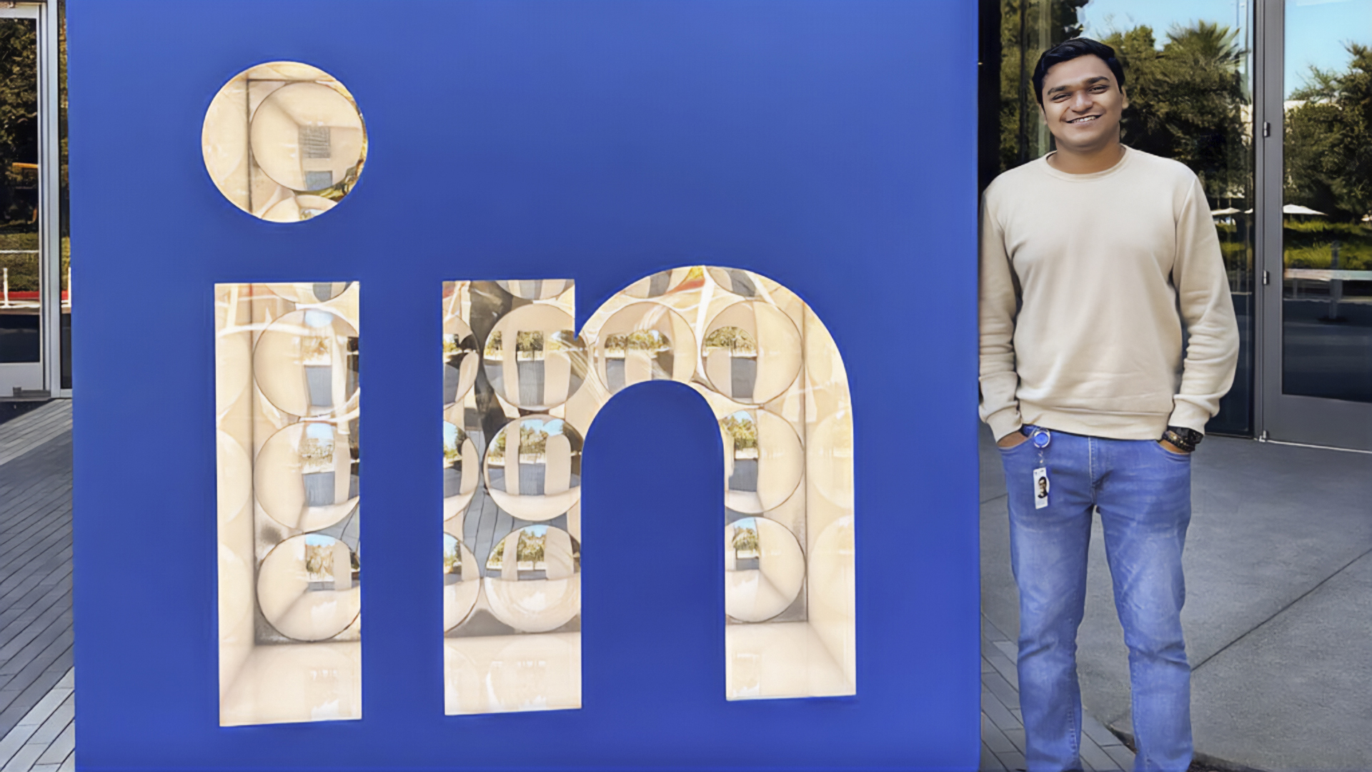 Manan Shah posed next to a large LinkedIn sign outside the company's headquarters in Sunnyvale, California.