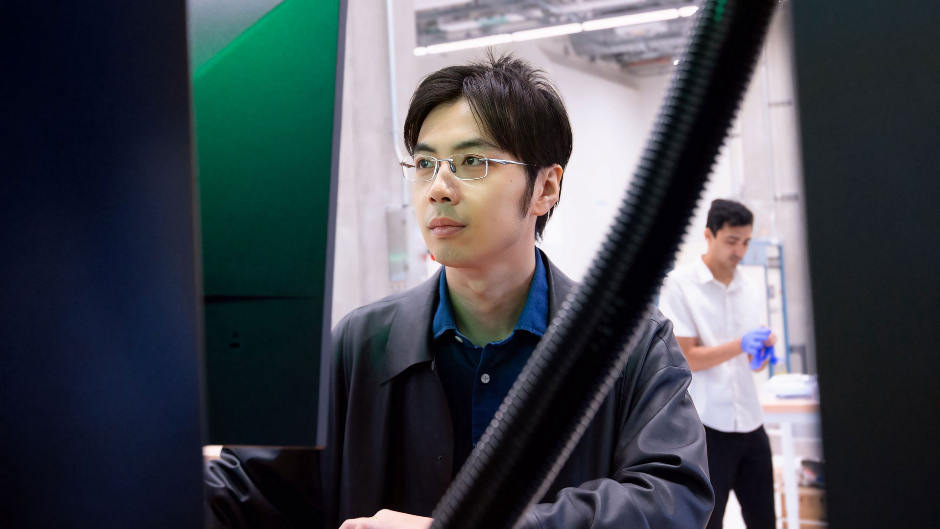 Zhengtao Gan operates a machine in the Reactive Materials 3D printing Lab.