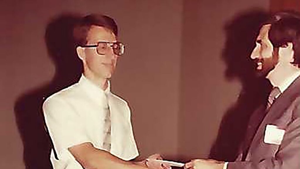 David Pheanis presents an award to student Chris Budd